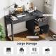 Modern black computer desk with spacious tabletop, large drawer, and cabinet for ample storage in a stylish design.