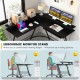 L-shaped black computer desk with ergonomic monitor stand, power outlet, and adjustable foot pads for stable workspace.
