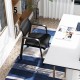 Stackable rolling office chair with a black mesh backrest and padded seat, ideal for comfortable workspace seating.