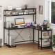 L-shaped reversible gaming desk in black with LED strip, power outlets, and adjustable shelves for organized workspace.