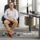 Massage adjustable executive chair in black with armrests and retractable footrest for ergonomic support and relaxation.