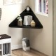 Floating triangular corner desk in black with storage shelf, perfect for compact spaces in living room or office.