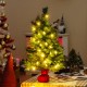 Mini 24-inch pre-lit Christmas tree with warm white LED lights and red cloth base, perfect for tabletop holiday decor.