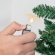 Hand holding a lighter near a 7.5 feet artificial Christmas tree, showcasing its lush PVC branch tips for festive decor.