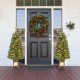 Pre-lit 4 feet potted Christmas tree with flowering pine needles and warm LED lights, perfect for festive outdoor decor.