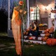 6-foot hanging pumpkin ghost with red glowing eyes and poseable arms, perfect for creating an eerie outdoor Halloween.