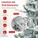 Close-up of the snow flocked branches of a 7 feet artificial Christmas tree with cool white LED lights for festive.