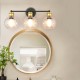 Modern 3-light bubbled glass vanity light with black and gold finishes, perfect for enhancing bathroom decor.