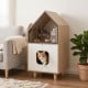 Modern cat litter box enclosure with house-shaped design, dual doors, and upper shelf for cat supplies in a living room setting.