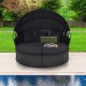 Round black wicker patio daybed with retractable canopy and cushions, perfect for outdoor relaxation by the pool.