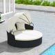 Round clamshell patio daybed in off-white with retractable canopy and cozy pillows, perfect for outdoor relaxation.