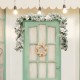 Snow flocked 9 feet pre-lit artificial Christmas garland with 50 LED lights, adorned with white flowers and berries.