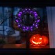 24-inch pre-lit Halloween wreath with 35 purple LED lights, enhancing spooky decor for festive celebrations.