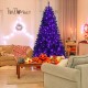 Black 7' artificial Christmas Halloween tree with purple LED lights, showcasing a spooky glow in a cozy living room.