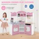 Wooden corner play kitchen in pink with coffee machine, slide, and interactive features for kids aged 3 and up.