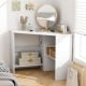 Corner computer desk in white with triangle design, spacious tabletop, and storage shelves for organized workspace.