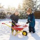 Two children playing in the snow with a red kids wheelbarrow, featuring all-terrain wheels for outdoor fun.