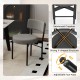 Gray dining chair with padded seat and curved backrest, featuring a sturdy X-shaped structure and adjustable foot pads.