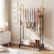 Double rods garment rack in gold and black with side hooks, bottom shelf, and stylish design for bedroom or entryway.