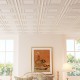 White 3D decorative drop ceiling tiles in a room setting, showcasing a modern design for versatile installation.