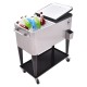 Stainless steel 80 quart rolling ice beverage cooler with two access lids, casters, and a bottom shelf for storage.