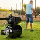 Black 1200 W garden water pump with yellow hose, ideal for pressurized irrigation and transferring water efficiently.