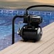 Black 1200 W garden water pump on a deck by a pool, ideal for pressurized irrigation and water transfer.