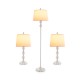 Three-piece table and floor lamp set with metal construction and soft glow, perfect for modern interiors.