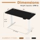 Electric standing desk in black with height adjustment, 3 memory settings, and cable management for organized workspace.