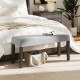 Gray end of bed bench with padded velvet seat and solid wood legs, perfect for bedroom or entryway storage.