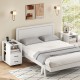 White end table with built-in charging station, two drawers, and wheels for easy movement beside a bed.