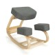 Ergonomic gray kneeling chair with curved wooden base, designed for upright posture and comfort, suitable for home or.