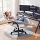 Ergonomic beige video game chair with headrest, reclining backrest, and retractable footrest for home office comfort.