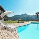 Chaise lounge with wide canopy in beige, featuring a sturdy steel frame, soft cushion, perfect for poolside relaxation.