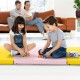 Children playing on a 6 x 2 FT tri-fold gym mat in yellow and pink, ideal for yoga and martial arts activities.