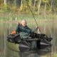 Portable fishing boat in green with detachable storage boxes, featuring rod holders and a comfy inflatable seat for.
