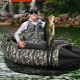 Inflatable fishing float tube in camouflage with adjustable backrest, featuring a fisherman holding a large bass.