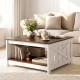 Farmhouse coffee table with a white finish and brown top, featuring a storage shelf for books and decor.