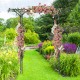 Garden arbor with trellises for climbing plants, featuring a decorative arch and vibrant floral arrangements, ideal for.
