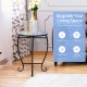 Round accent table with cobalt blue mosaic top and black steel legs, perfect for indoor or outdoor plant display.