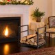 Firewood log rack in black with raised feet and handles, designed for easy storage and stability by the fireplace.