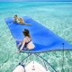 Two women relax on a 9' x 6' blue floating water pad made of eco-friendly XPE foam in clear water.