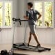Folding treadmill with LCD display, 12 preset programs, and 7-layer non-slip running belt for home workouts.
