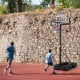 Foldable basketball hoop with adjustable height, sturdy base, and shatterproof backboard for outdoor play.