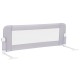 Light gray foldable bed rail with soft padding and adjustable strap, designed for toddler safety and easy access to bed.