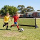 Portable 5 x 3 FT pop-up football goal with kids playing soccer on grass, ideal for backyard and playground training.