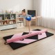 Folding gymnastics mat with portable balance beam, featuring pink and black design, ideal for home training and skill.