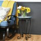Mosaic side table with ceramic tile top and black steel frame, perfect for indoor or outdoor use beside a sofa.