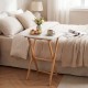 Folding TV tray table in white with bamboo structure, perfect for small spaces in bedroom or living room.
