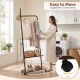 Freestanding clothing rack with wheels in rustic brown, showcasing a heavy-duty metal frame and adjustable foot pads.